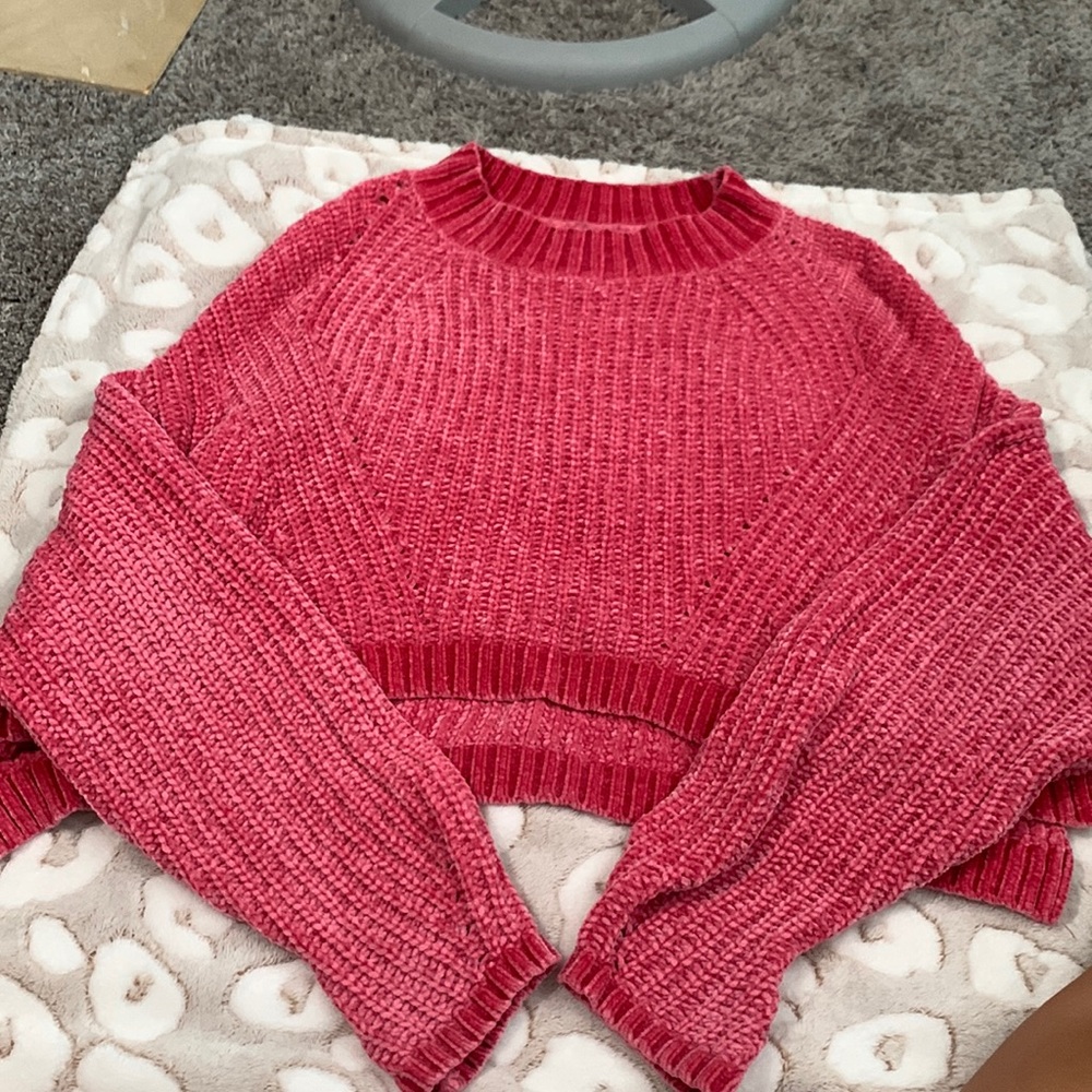 Cute pink rue21 sweater. longer in the back. kind of cropped. sleeves are long.
